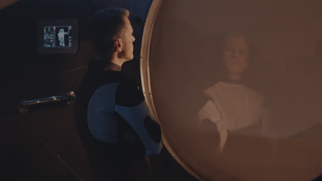 man observing reflection in a futuristic space environment