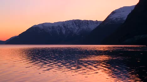 A-perfect-reflection-of-gold-and-red-light-in-a-mountain-lake-at-sunset