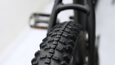 sliding shot of rear mountain bike tire in studio