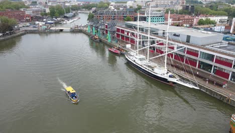 bristol city waterfront docks pleasure boat cursing along river uk aerial footage 4k