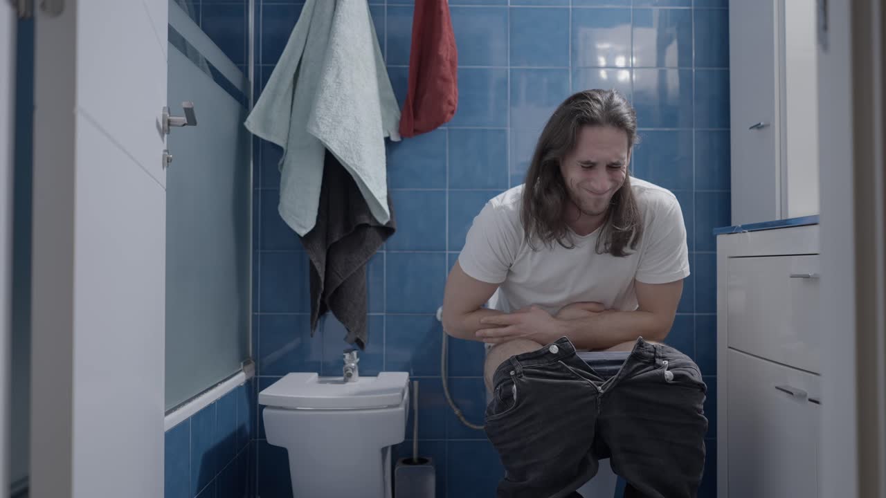 Man Experiencing Digestive Issues in Bathroom