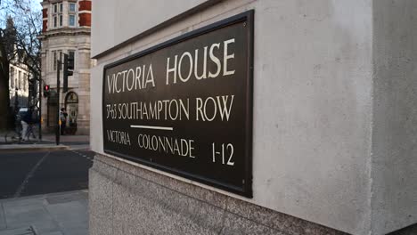 cyclists speeding through london and the victoria house, 37-63 southampton row, united kingdom