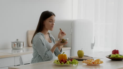 mujer embarazada comiendo pepinillos y alimentos saludables