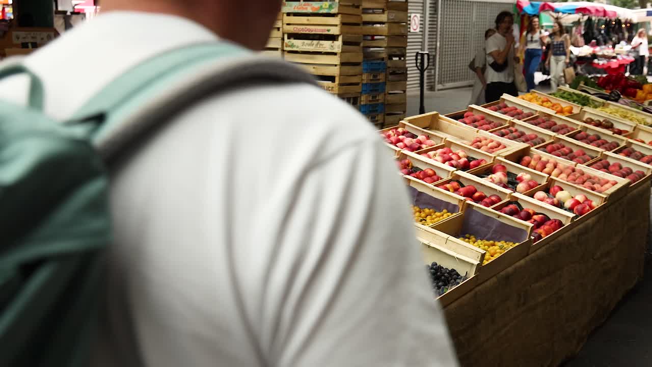 Father and child browsing fresh fruit stalls