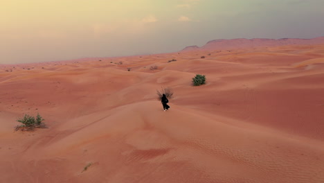 mujer en hijab explorando el desierto