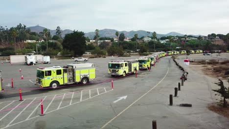 aerial of firefighters in fire trucks lining up for duty at a staging area during the thomas fire in ventura california in 2017 1