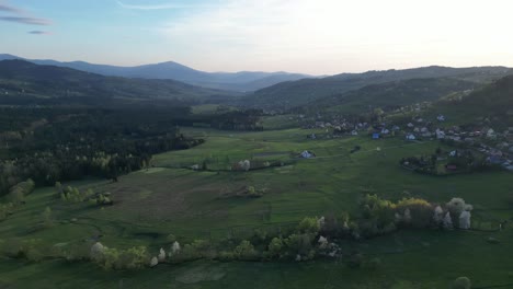 mountains landscape during a summer day with mountains peaks, forest, lush greenery and trees