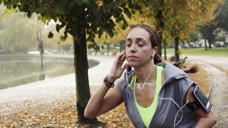 runner woman running in park exercising outdoors fitness tracker wearable technology