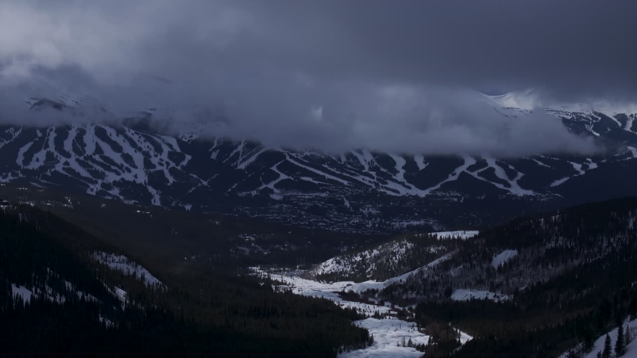 Ten Mile Breck Peaks Breckenridge Ski resort town Vail Epic Ikon Pass aerial drone landscape cloudy fog sunny winter morning ski trail runs Summit County Tiger fork road Rocky Mountains down motion