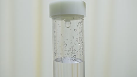 Close-up of an intravenous drip dripping from a medical infusion line