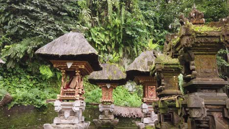 ancient balinese stone temple architecture with haired roof in the lush forest, bali indonesia traditional hindu sacred buildings, pura mengening tampaksiring