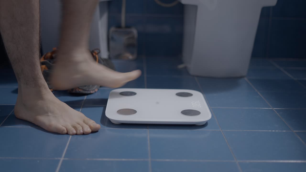 Man standing on a bathroom scale