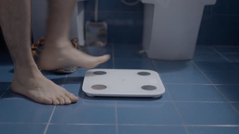 man standing on a bathroom scale