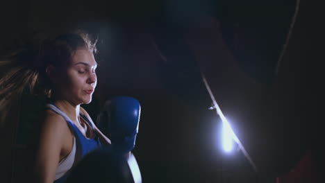 Beautiful-Kickboxing-woman-training-punching-focus-mitts-in-fitness-studio-fierce-strength-fit-body-kickboxer-series