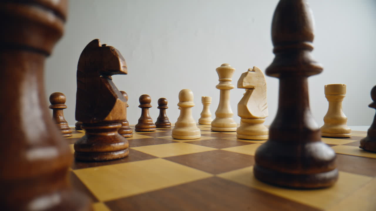 Chess player hand move strategic on chessboard closeup. Arm placing knight piece