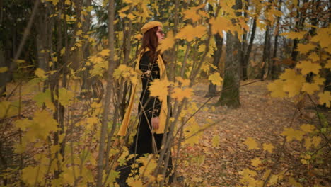 stylish lady in yellow beret and scarf wanders through the woods, admiring the gently swaying retreat leaves and enjoying the tranquil natural setting