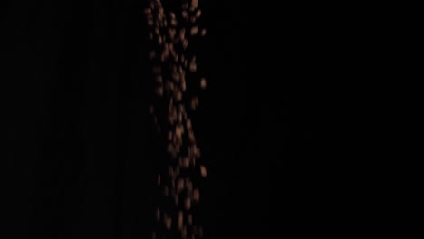 coffee beans pouring with black background, slow motion