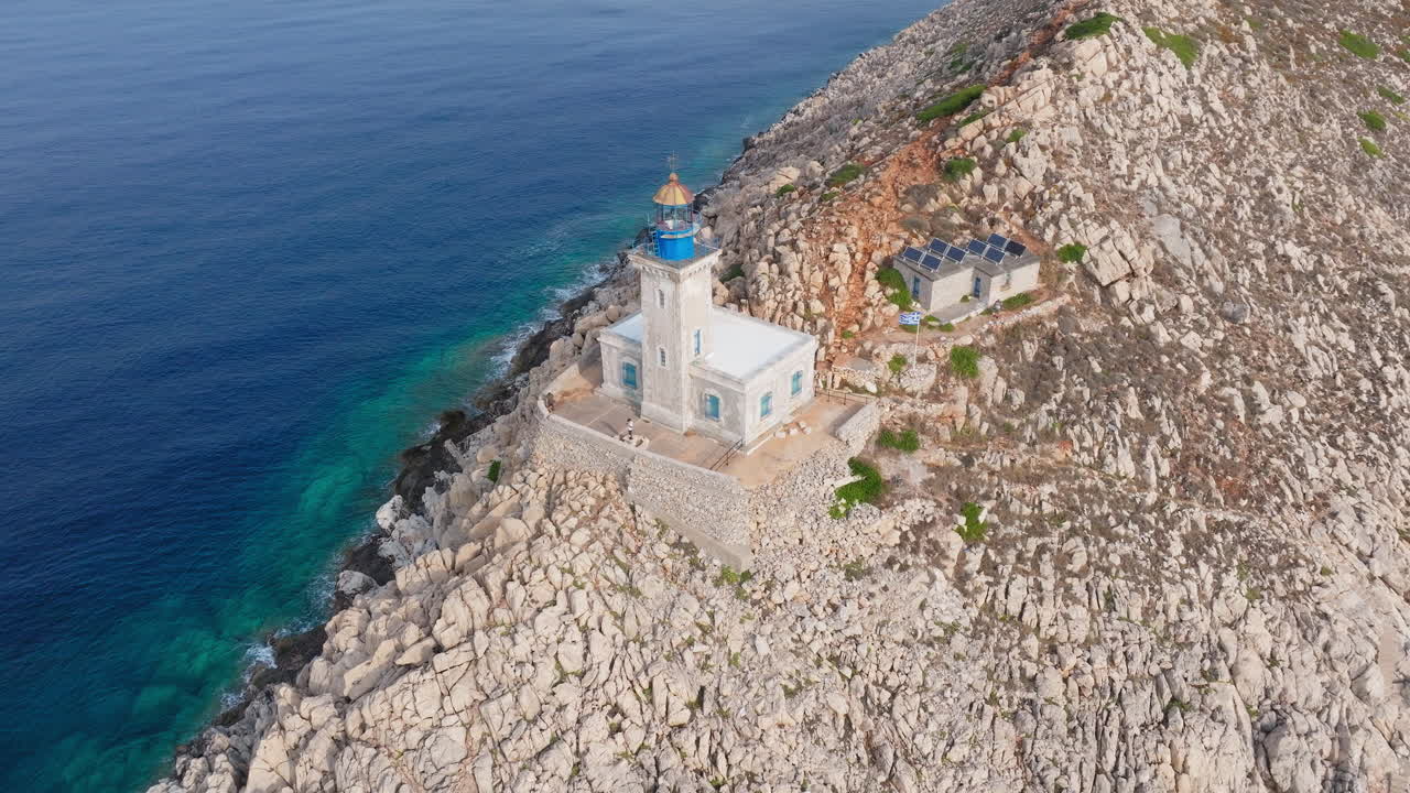 Drone circles around Cape Tainaron lighthouse on rocky coastline at the end of Mani Peninsula, Peloponnese, Mediterranean sea, Panoramic view