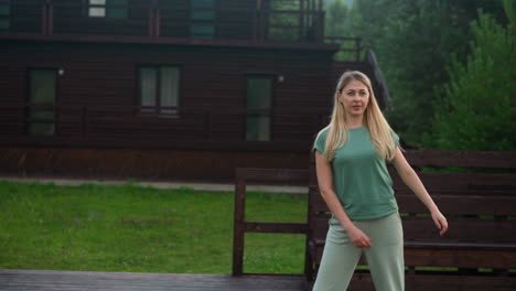 Woman-in-sportswear-does-sidesteps-on-ground-near-hotel