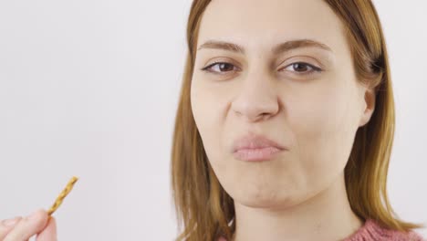 close-up portrait of woman eating cracker.