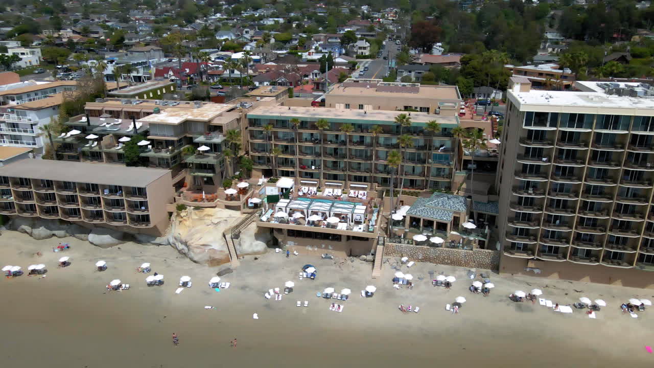Aerial View of a Beachfront Resort with Pool and Sandy Beach