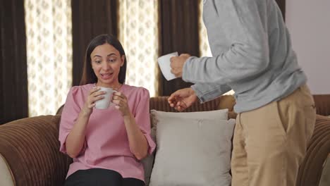 Handsome-Indian-husband-brings-tea-for-her-wife