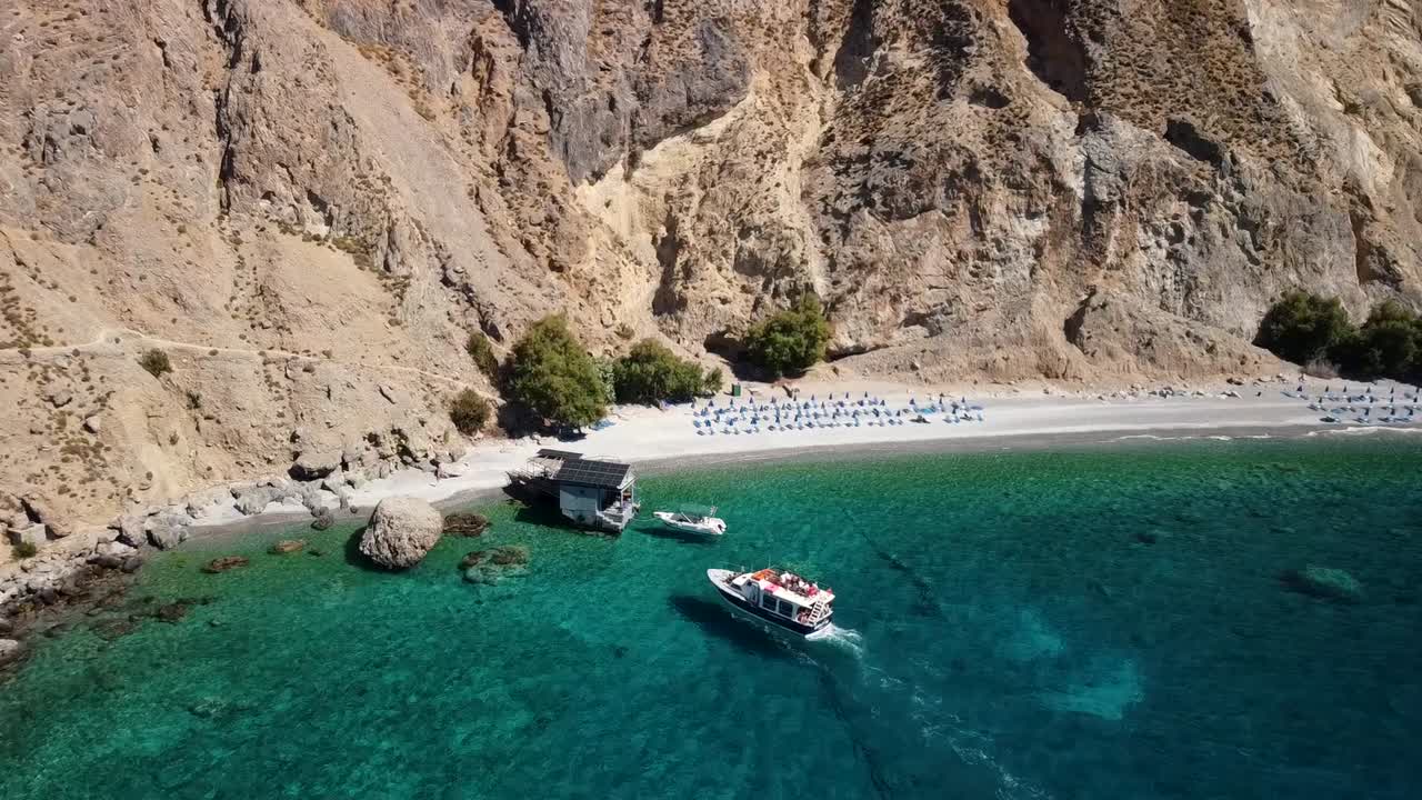 Bird's Eye View Of Tourists Disembarking Boat In Glyka Nera Sweet Water Beach In South Crete, Greece