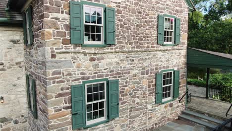 rising aerial reveals traditional colonial stone home