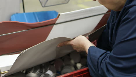 factory worker sorting parts of production line