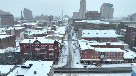 aerial reveal of american city covered in snow