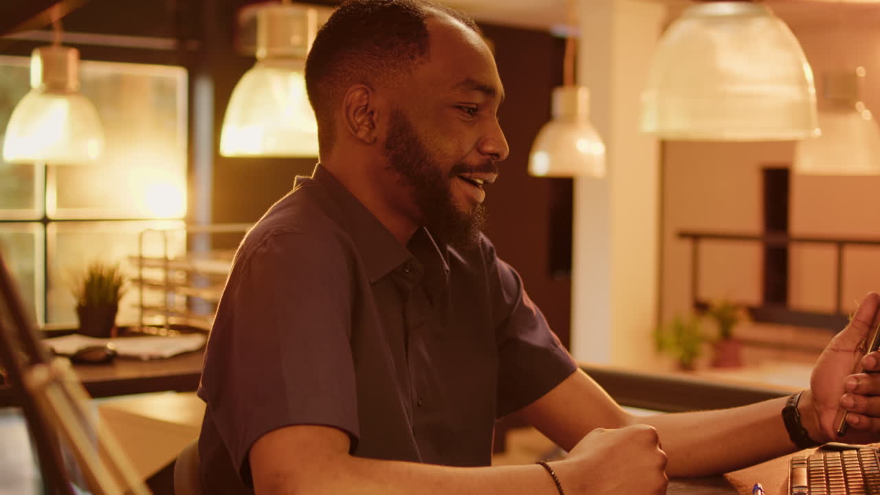 Man Using Smartphone at Desk in Office
