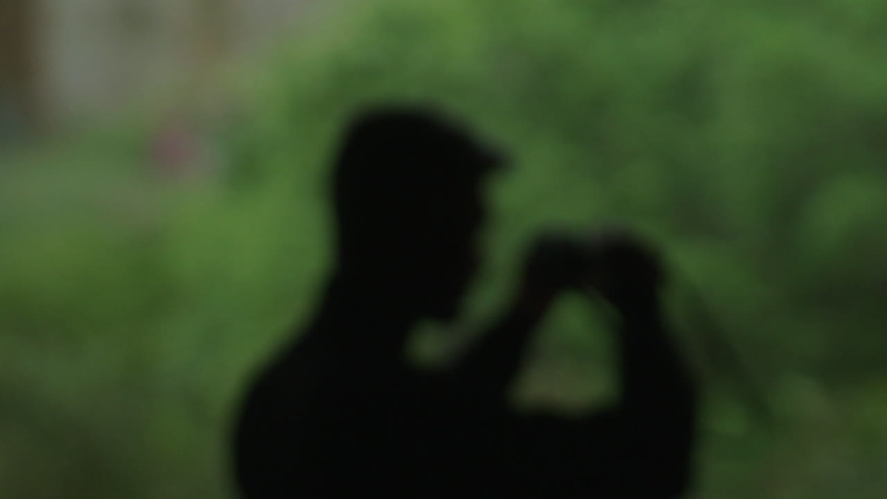 Blurred image of person taking a photo