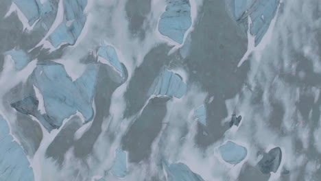 top down aerial view of icebergs, frozen lake, ice and snow abstract patterns, highlands of iceland