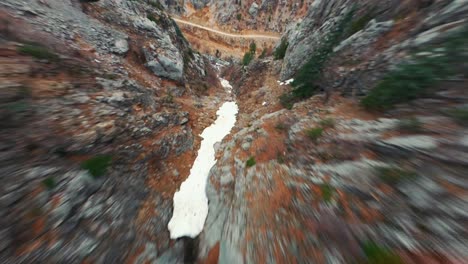 4k, drone flying down from the mountain towards the green, blue river