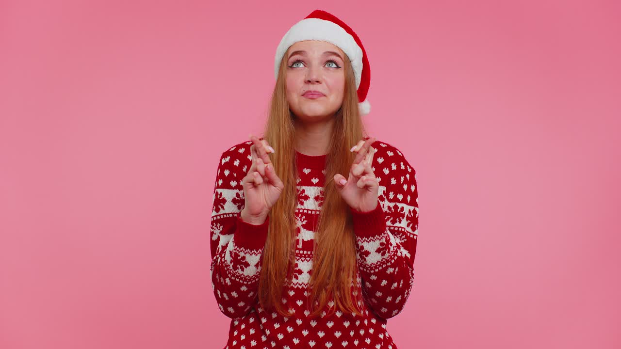 Woman in christmas sweater wish for good luck rejoices about receive longawaited gift celebration