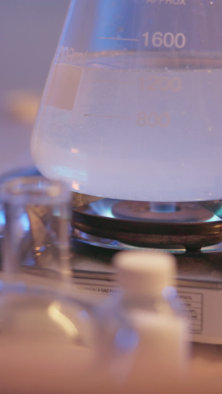 A beaker with liquid being heated in a laboratory