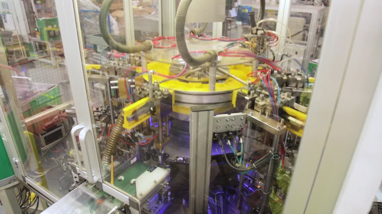 View Of Industrial Automated Assembly Line behind Safety Transparent Panel