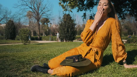 stylish young woman sending kiss to the camera outdoors.