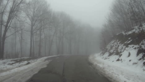 a car moves along a mountain road