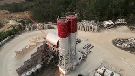 aerial view of a concrete batching plant with silos and mixer trucks
