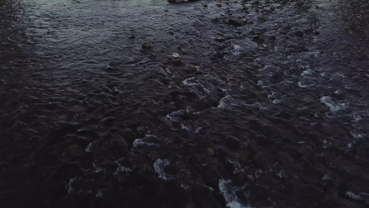 Rocky creek bed babbling brook in a residential neighborhood in Heber Utah - AERIAL DOLLY TILT PAN