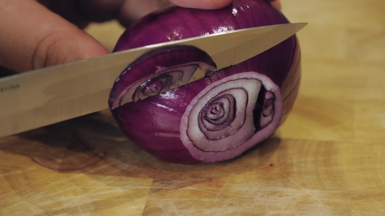 Motion controlled slow motion shot of cutting an onion