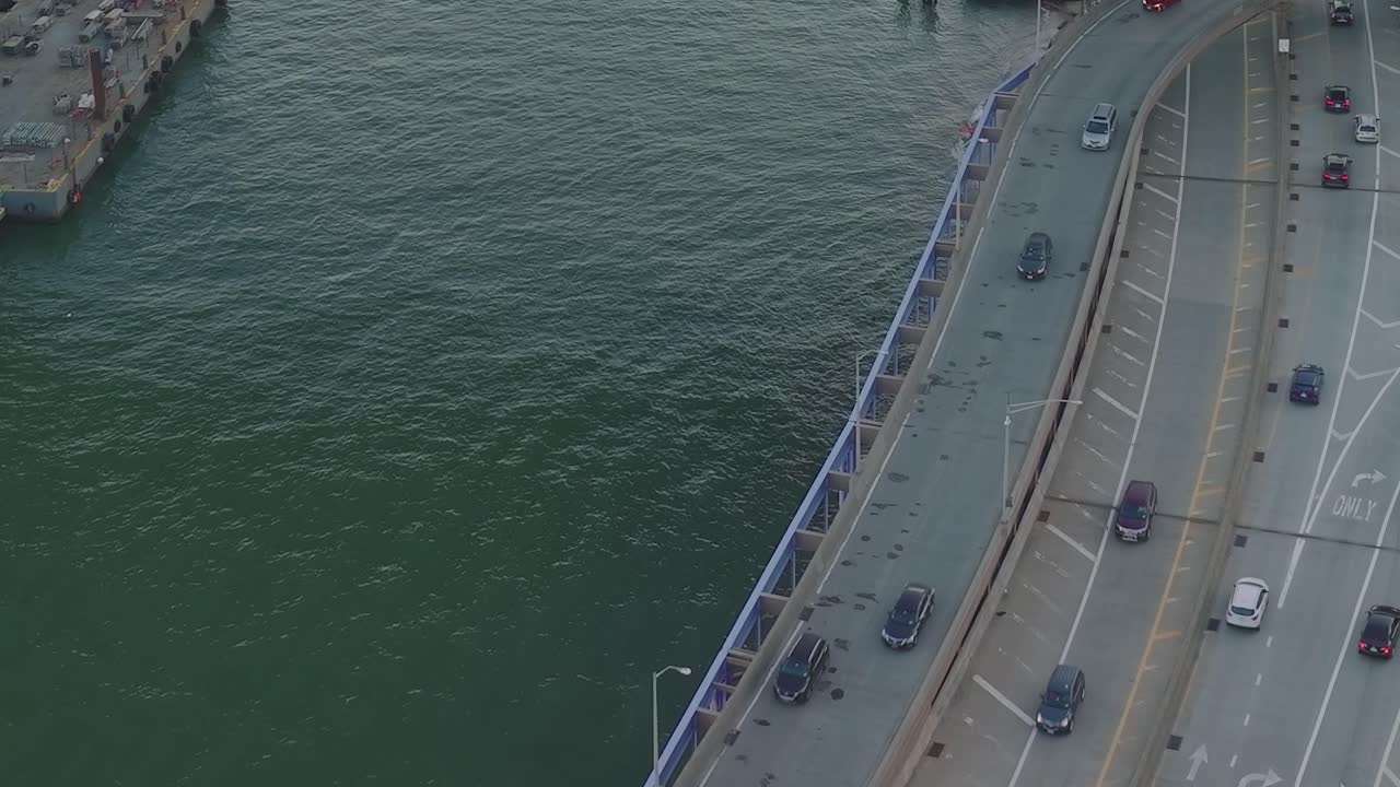 Aerial view of a bridge with cars and water