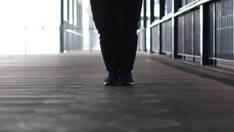 person jump roping indoors on a walkway