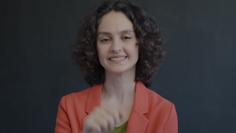woman smiling and making an ok gesture