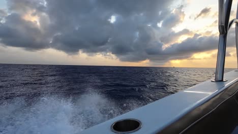 view from fast motorboat cruising through the caribbean sea at sunset
