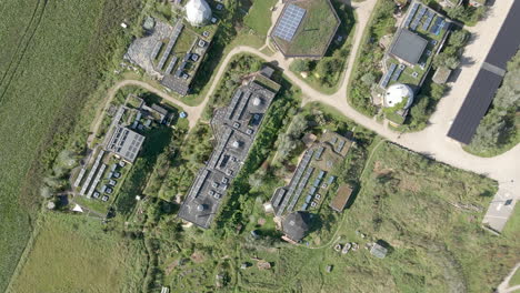 top down aerial of beautiful green earthship village