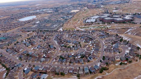 aerial view looking down as an airplane turns to land at the rocky mountain metropolitan airport