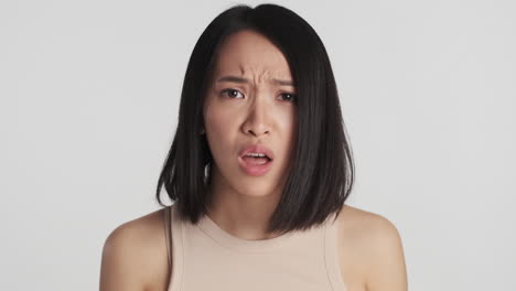 asian woman looking worried on camera.