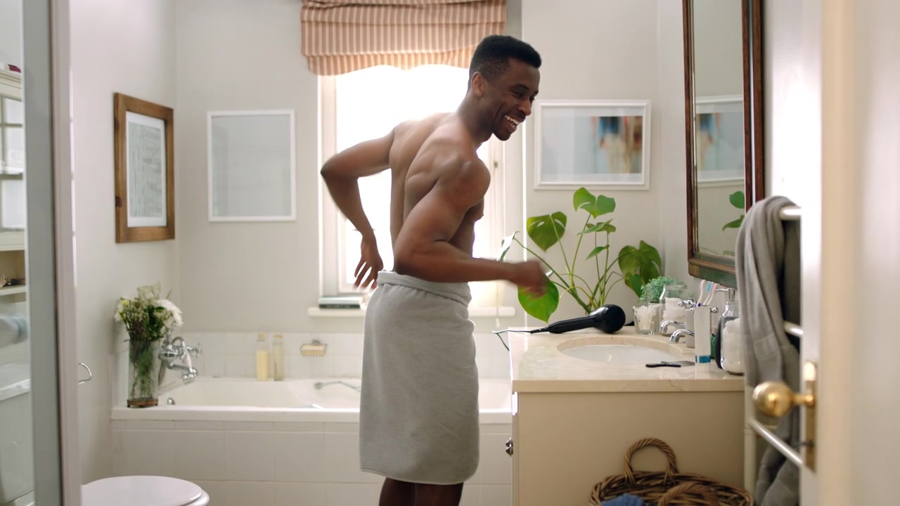 Young Man Dancing and Having Fun in Bathroom